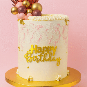 Gâteau d’anniversaire rose et doré décoré de perles, fleurs et topper doré – BGS Pâtisserie Nantes